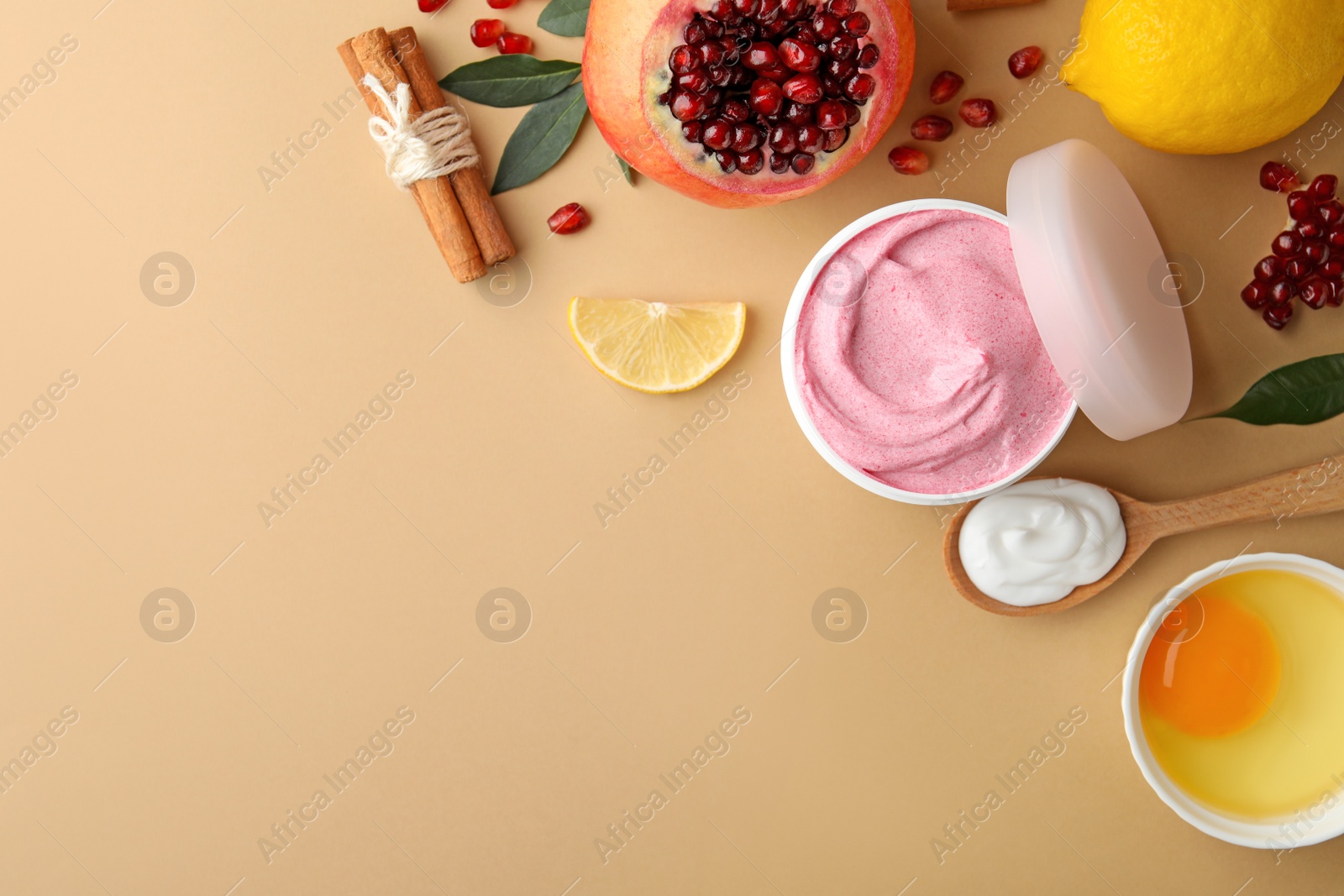 Photo of Flat lay composition with natural homemade mask, pomegranate and ingredients on beige background. Space for text