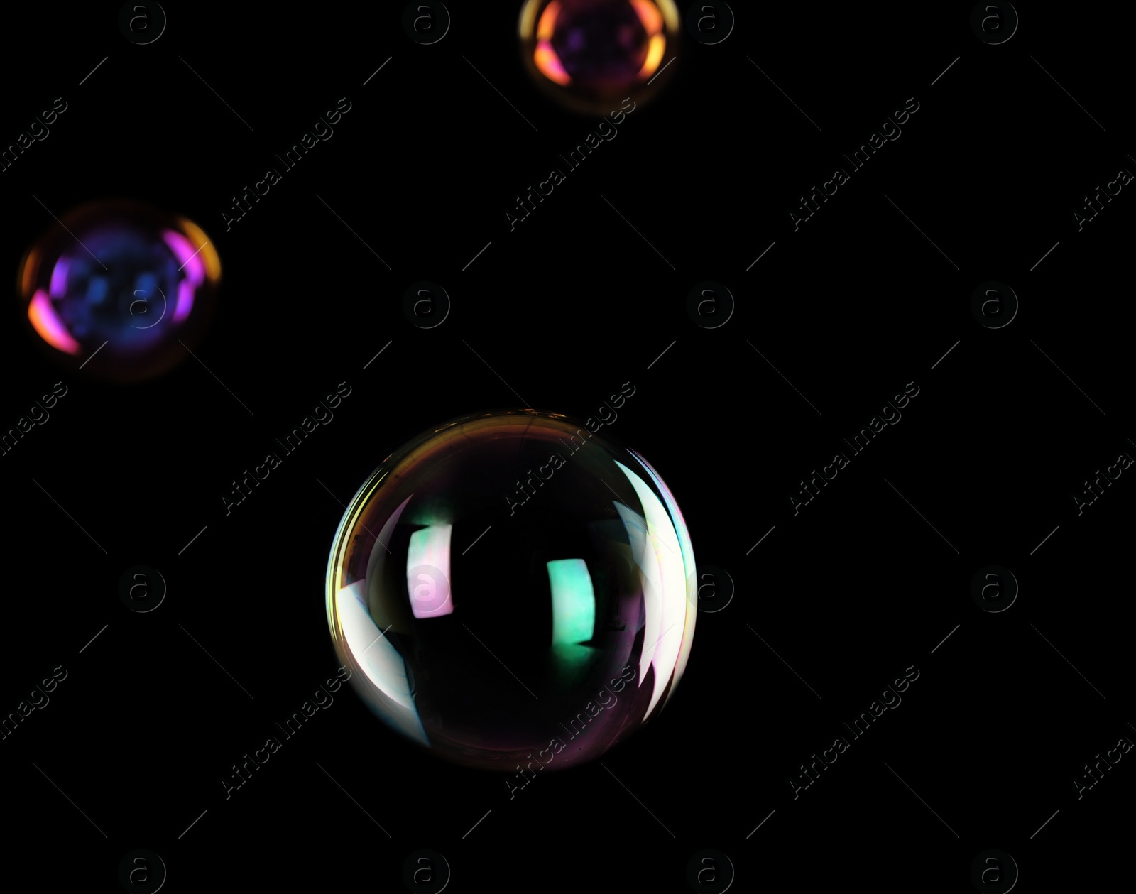 Photo of Beautiful translucent soap bubbles on dark background. Space for text