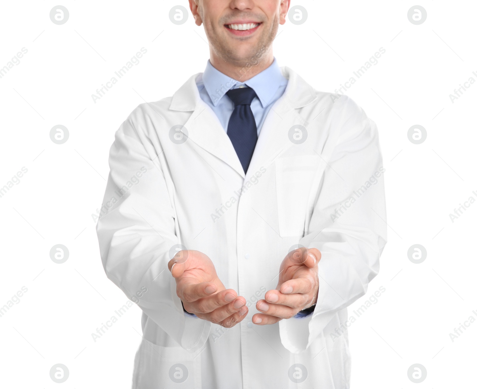 Photo of Male dentist holding something on white background