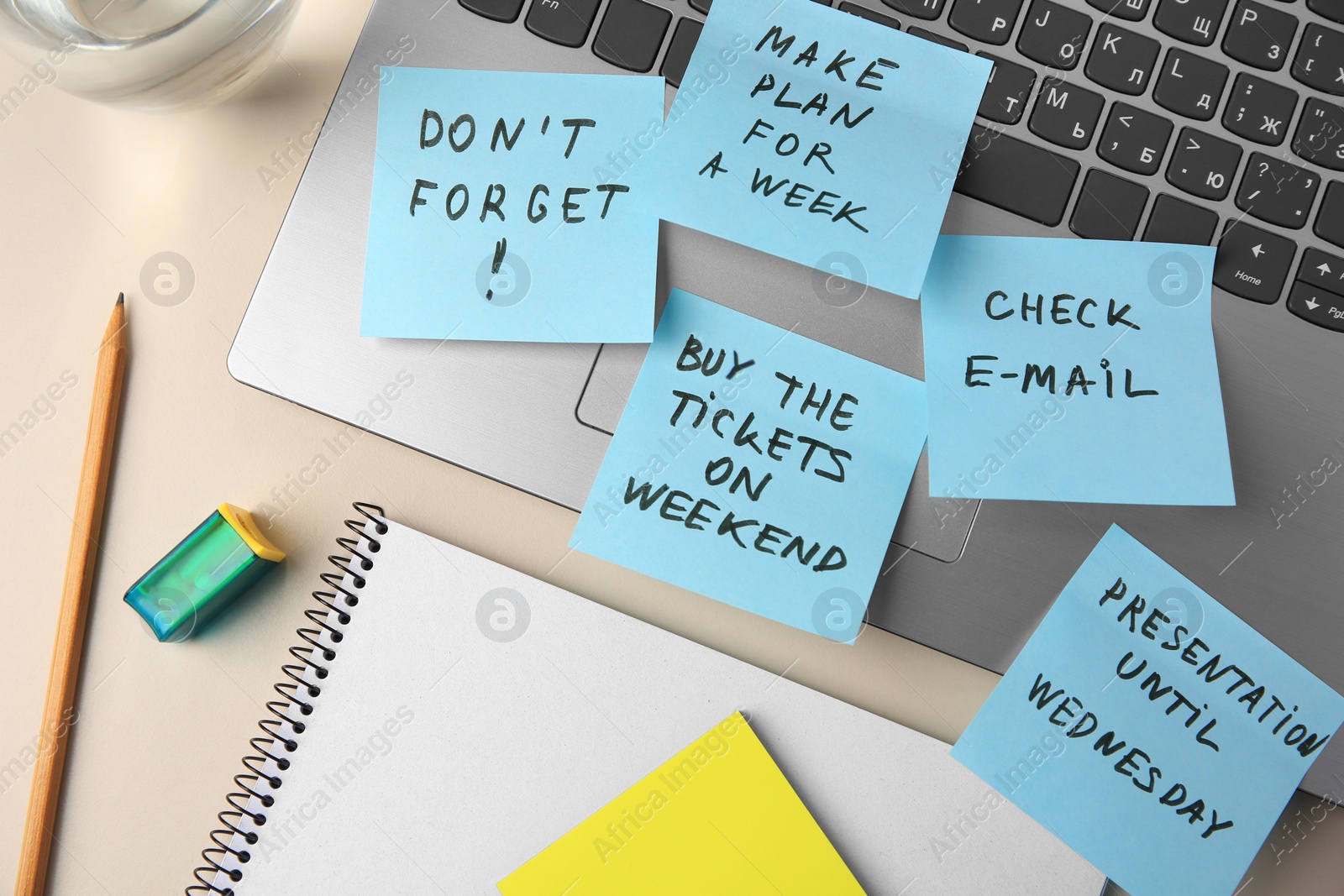 Photo of Different reminder notes and laptop on white table, flat lay