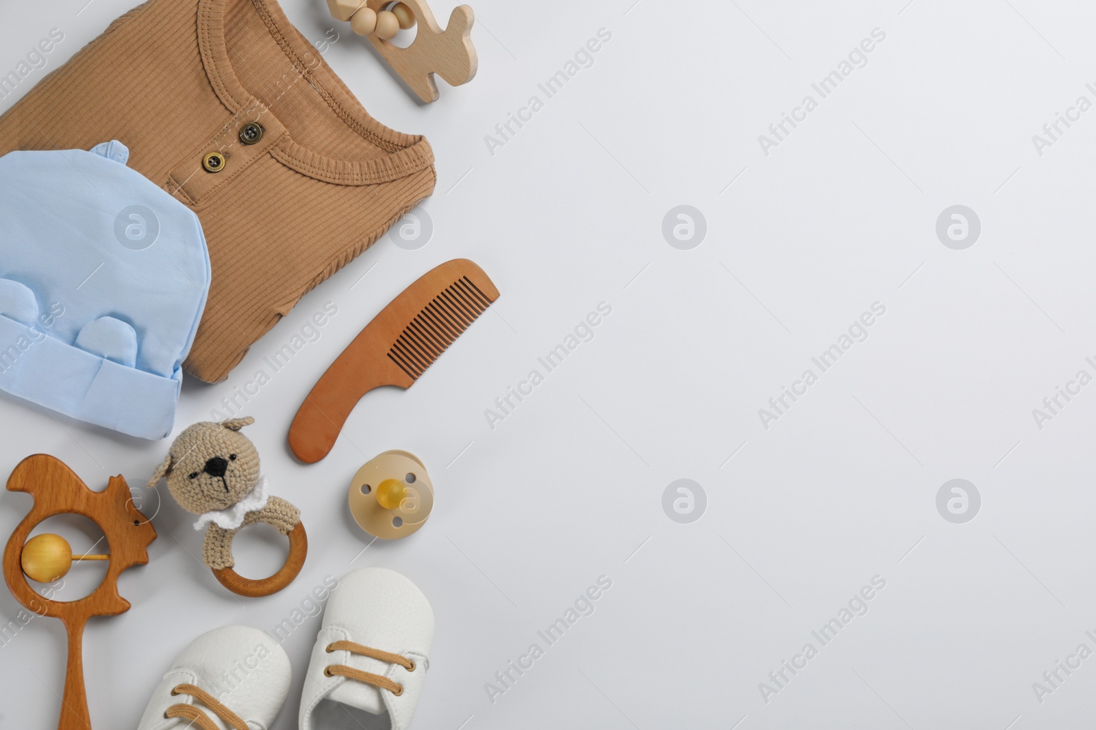 Photo of Flat lay composition with baby clothes and accessories on white background, space for text