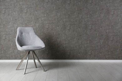 Grey modern chair for interior design on wooden floor at gray wall