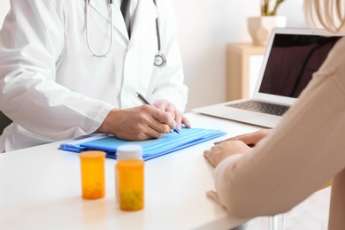 Male doctor consulting patient in clinic