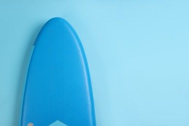 Photo of One SUP board on light blue background, top view with space for text. Water sport