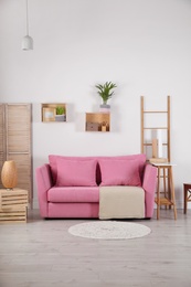 Modern living room interior with stylish pink sofa