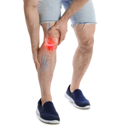 Young man suffering from knee pain on white background, closeup