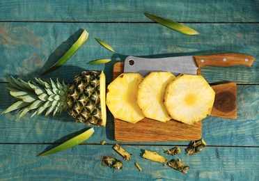 Photo of Cut fresh pineapple on wooden board