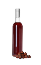 Photo of Delicious syrup and hazelnuts on white background