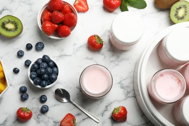 Photo of Modern yogurt maker with full jars and different fruits on white marble table, flat lay