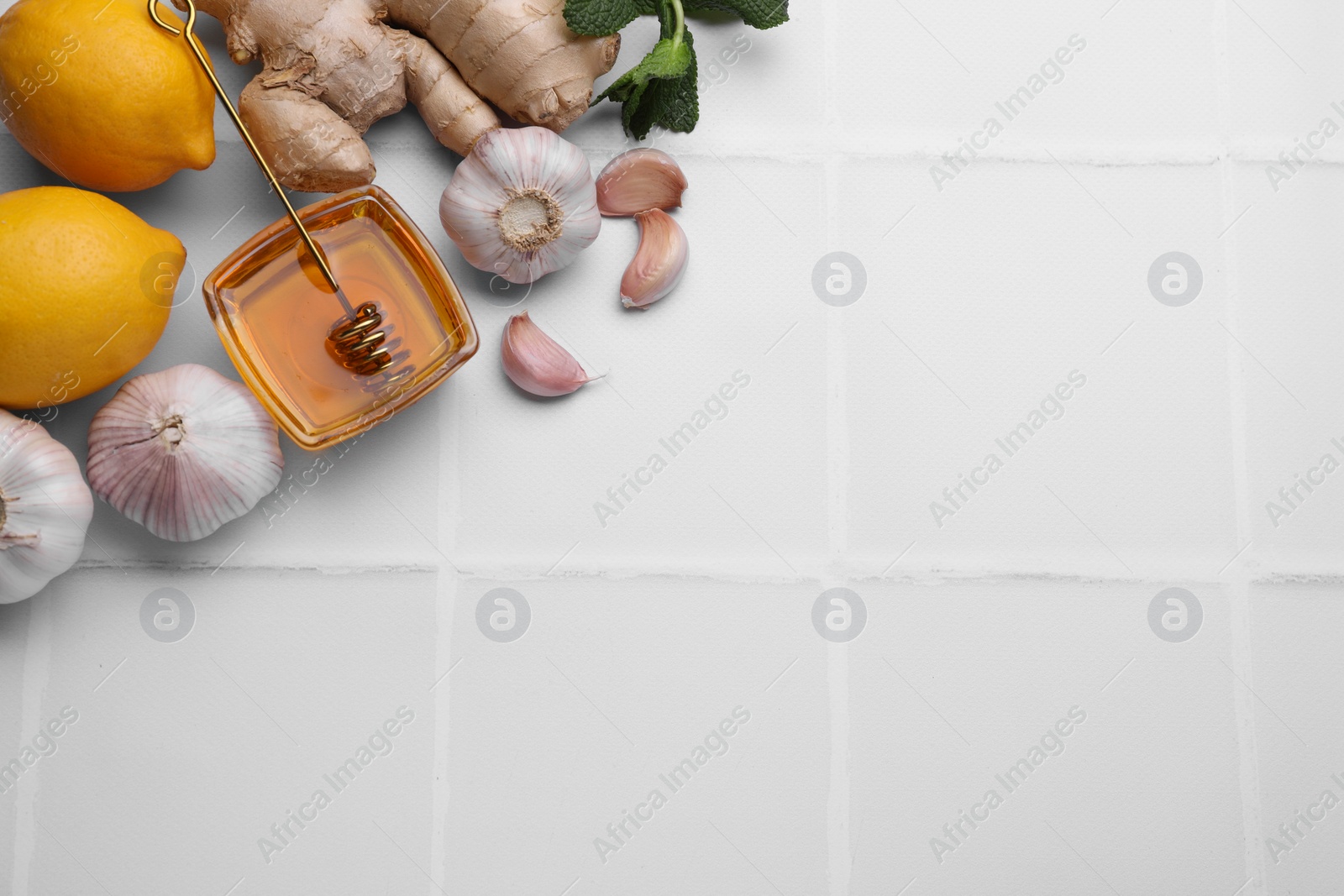 Photo of Cold remedies on white tiled table, flat lay and space for text. Cough treatment