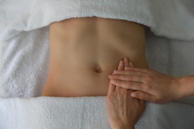 Photo of Woman receiving professional belly massage, closeup view