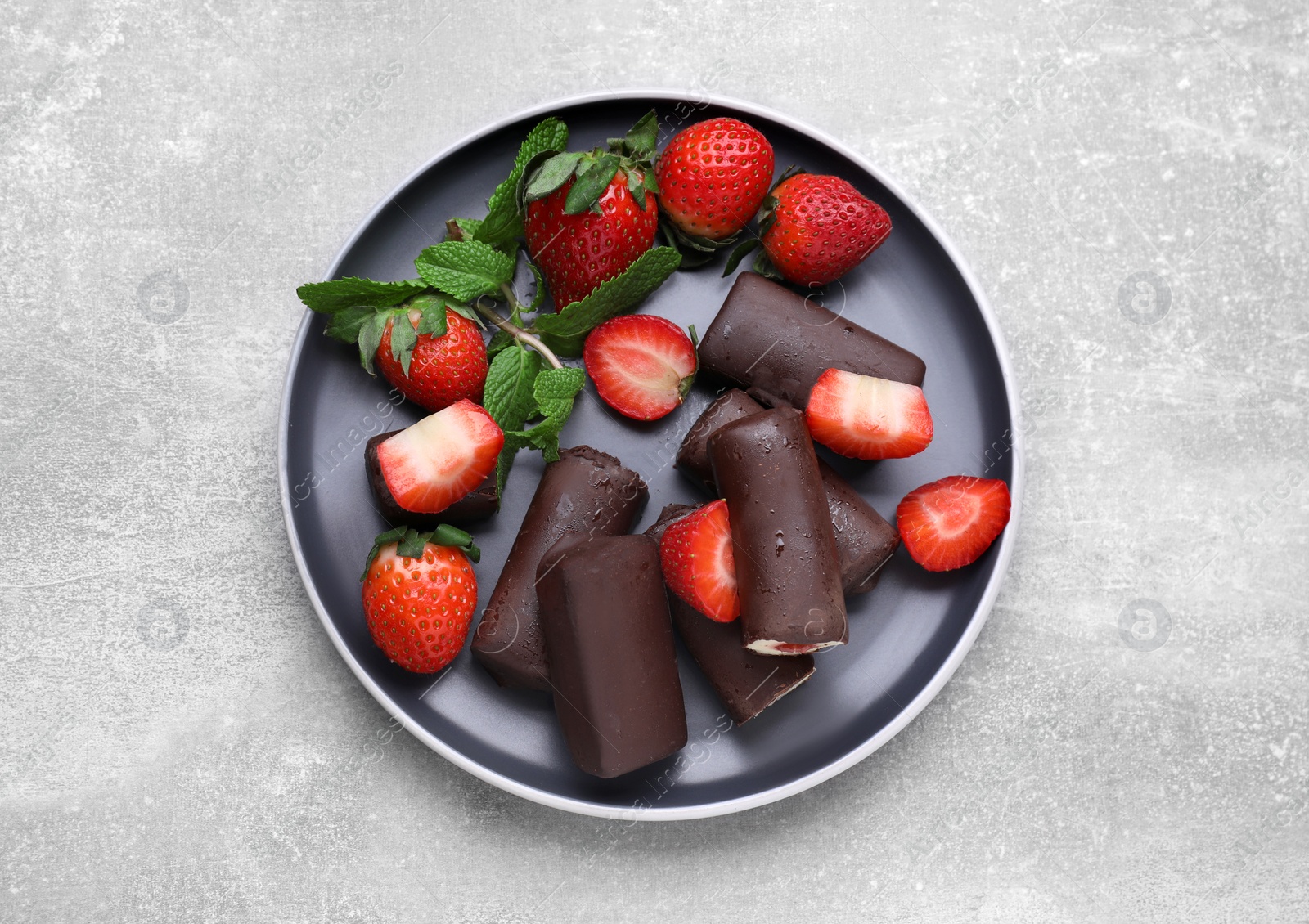 Photo of Delicious glazed curd snacks with fresh strawberries and mint on light grey table, flat lay