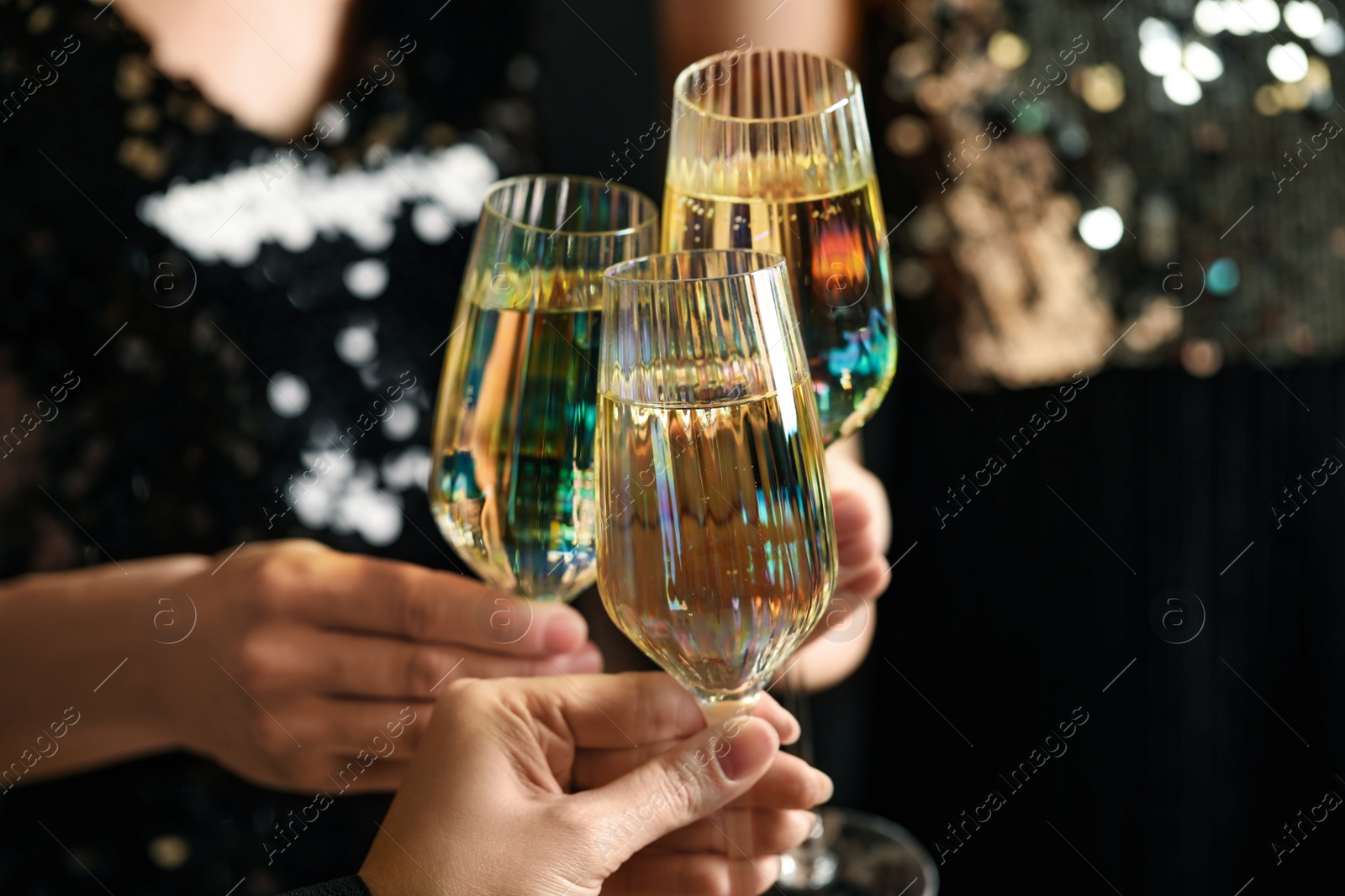 Photo of Women clinking glasses of champagne at party, closeup