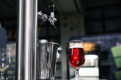 Glass of beer on bar counter in pub