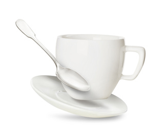 Image of Clean cup with saucer and teaspoon in flight on white background