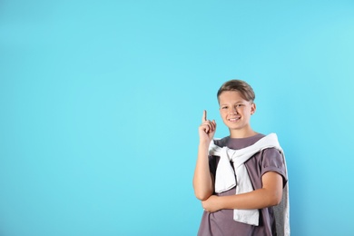 Photo of Teenage boy in casual clothes on color background