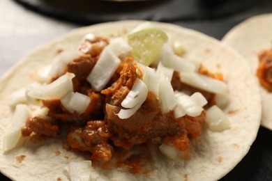 Delicious taco with vegetables and meat on table, closeup