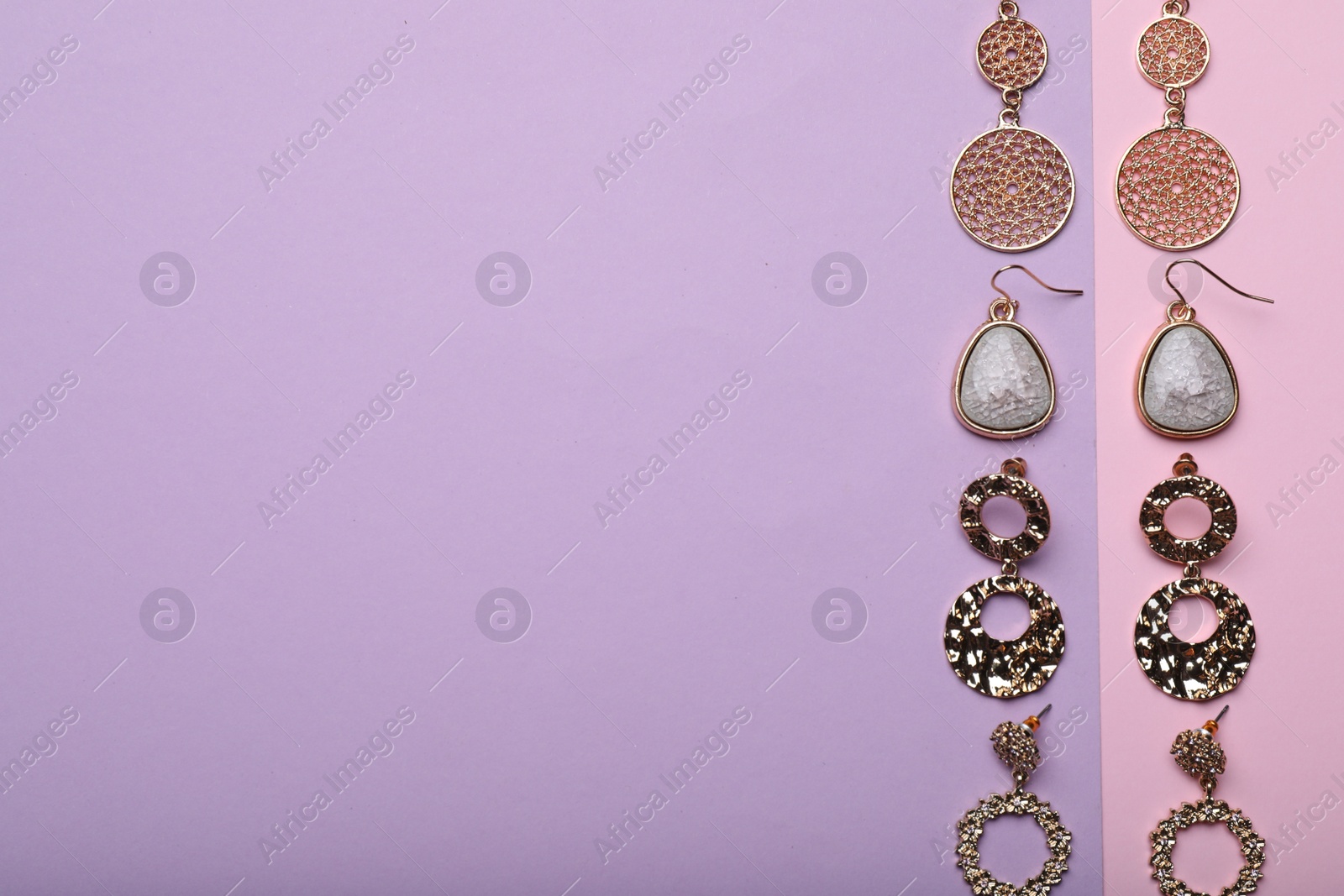 Photo of Different beautiful earrings on color background, flat lay. Space for text