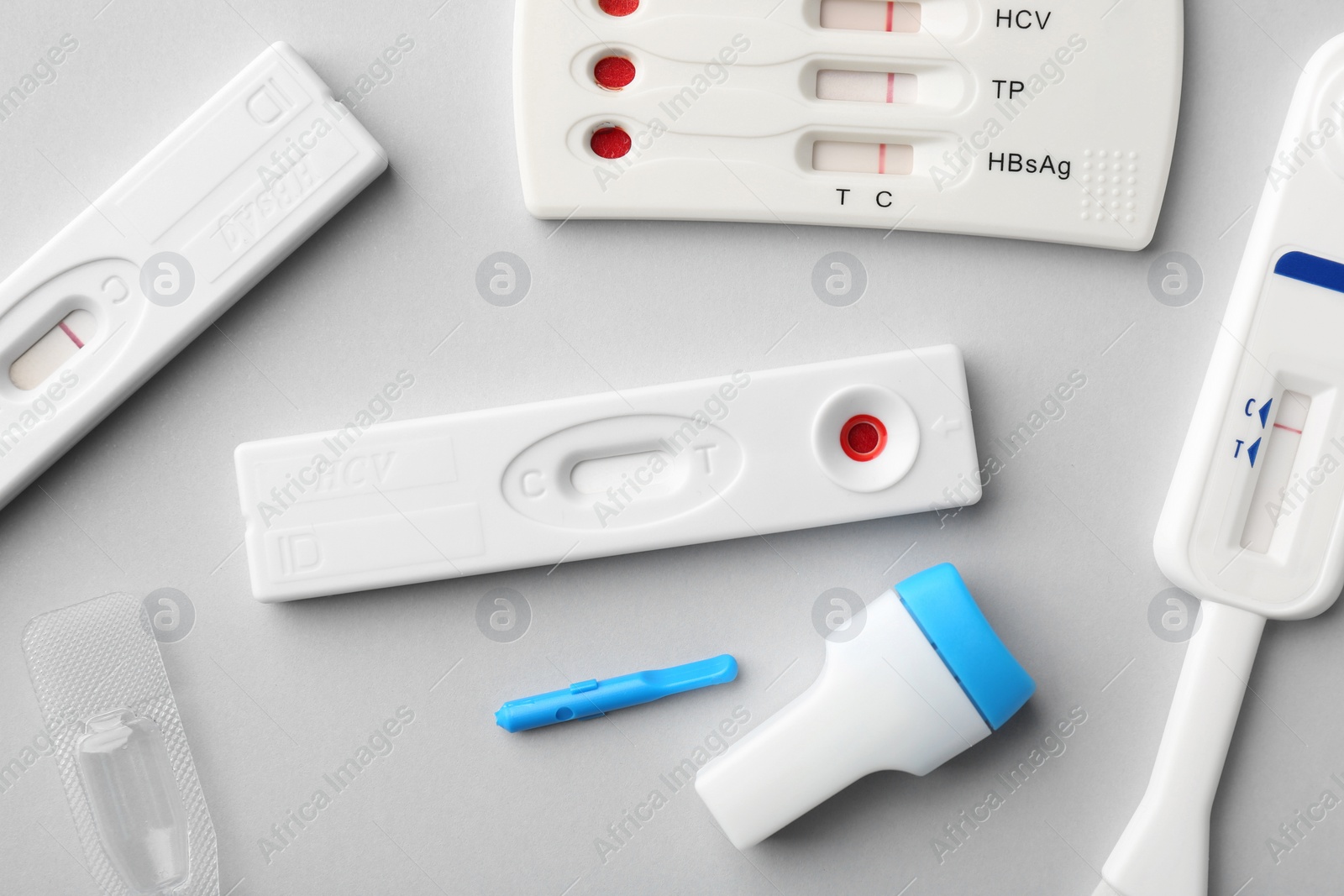 Photo of Different disposable express tests on light background, flat lay