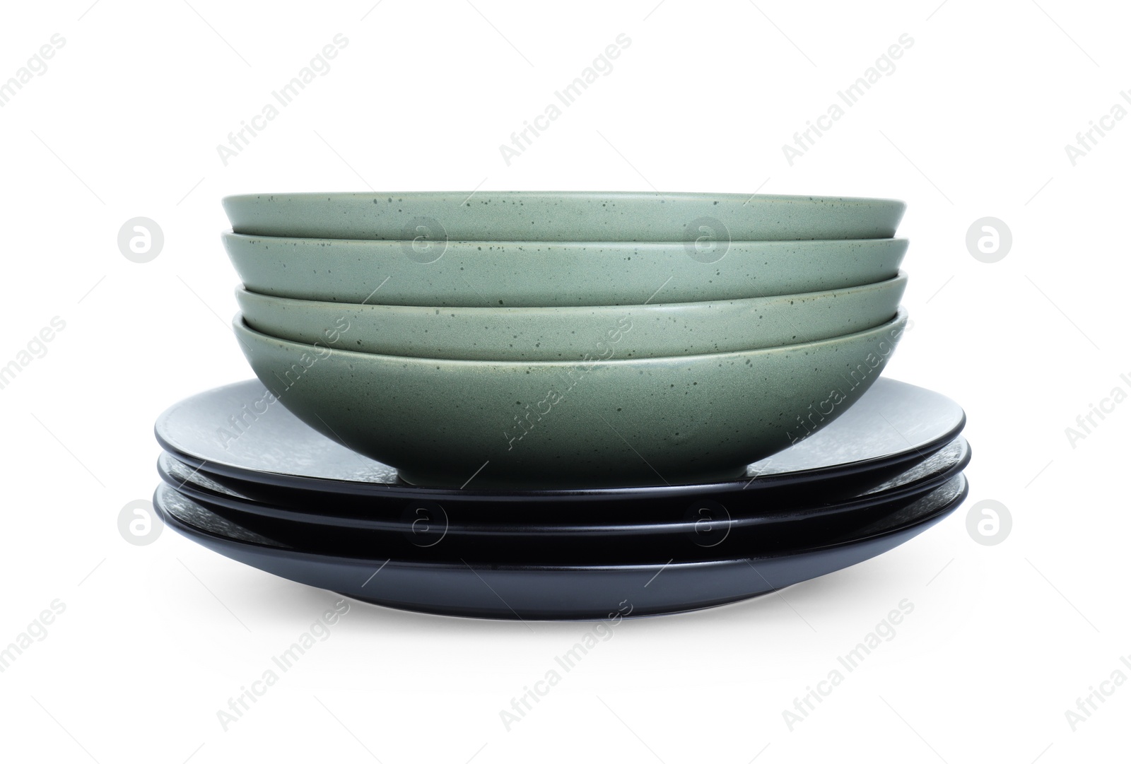 Photo of Stack of beautiful ceramic plates and bowls isolated on white