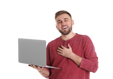 Young man using video chat on laptop against white background