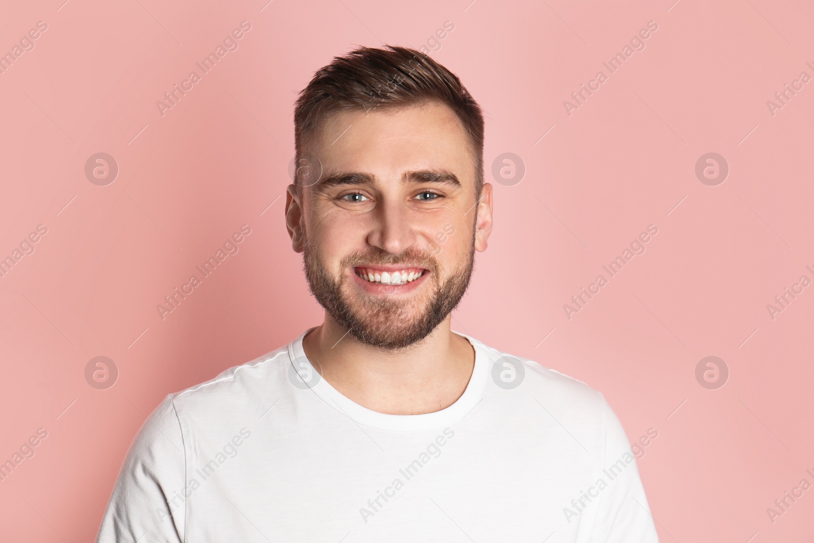 Photo of Young man with healthy teeth on color background