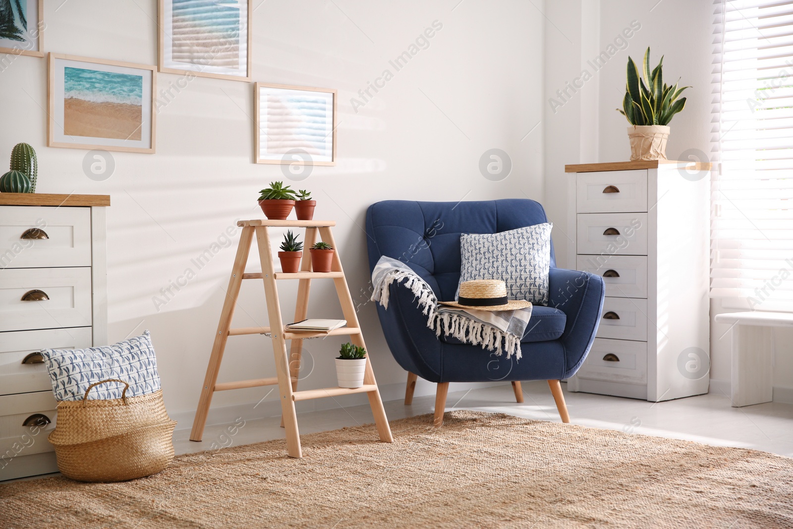 Photo of Stylish living room interior with wooden ladder and comfortable armchair