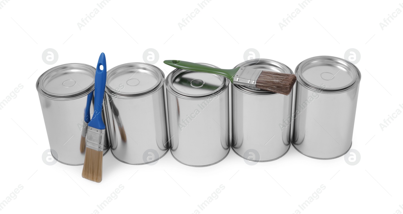 Photo of Cans of paints and brush on white background