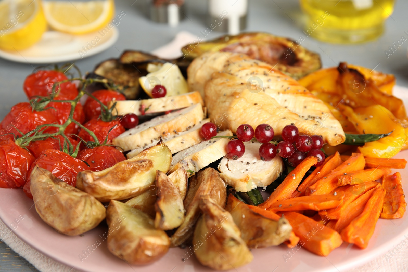Photo of Tasty cooked chicken fillet and vegetables on table, closeup. Healthy meals from air fryer
