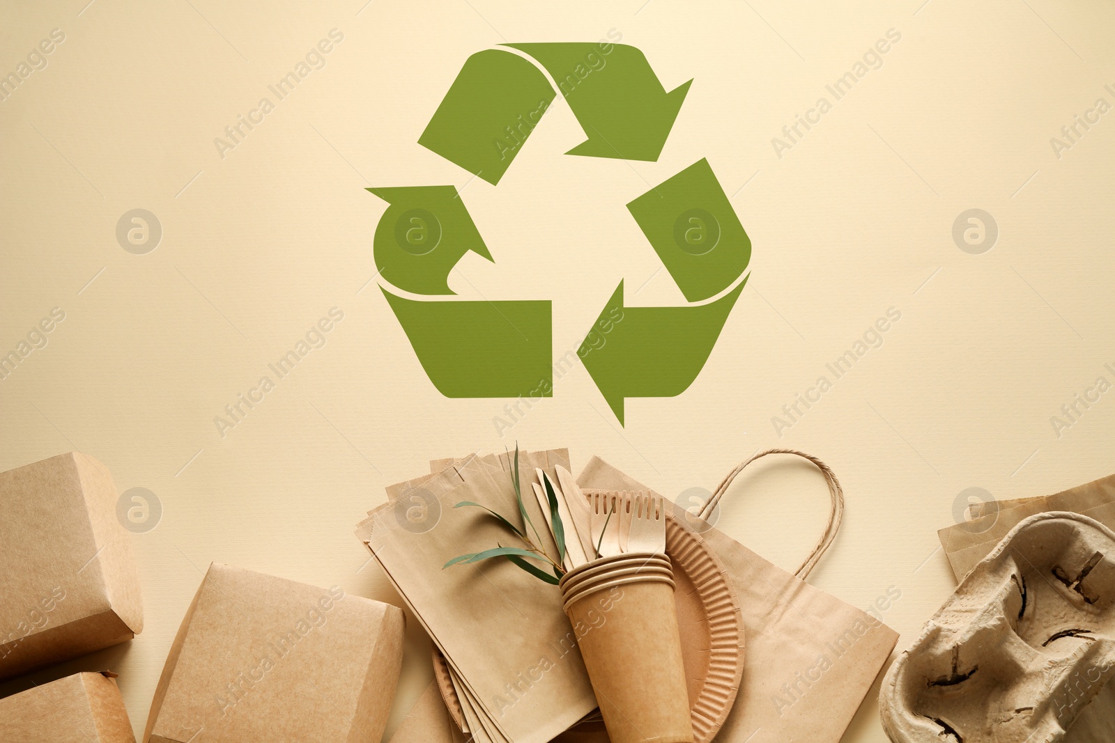 Image of Flat lay composition with eco friendly products and recycling symbol on beige background