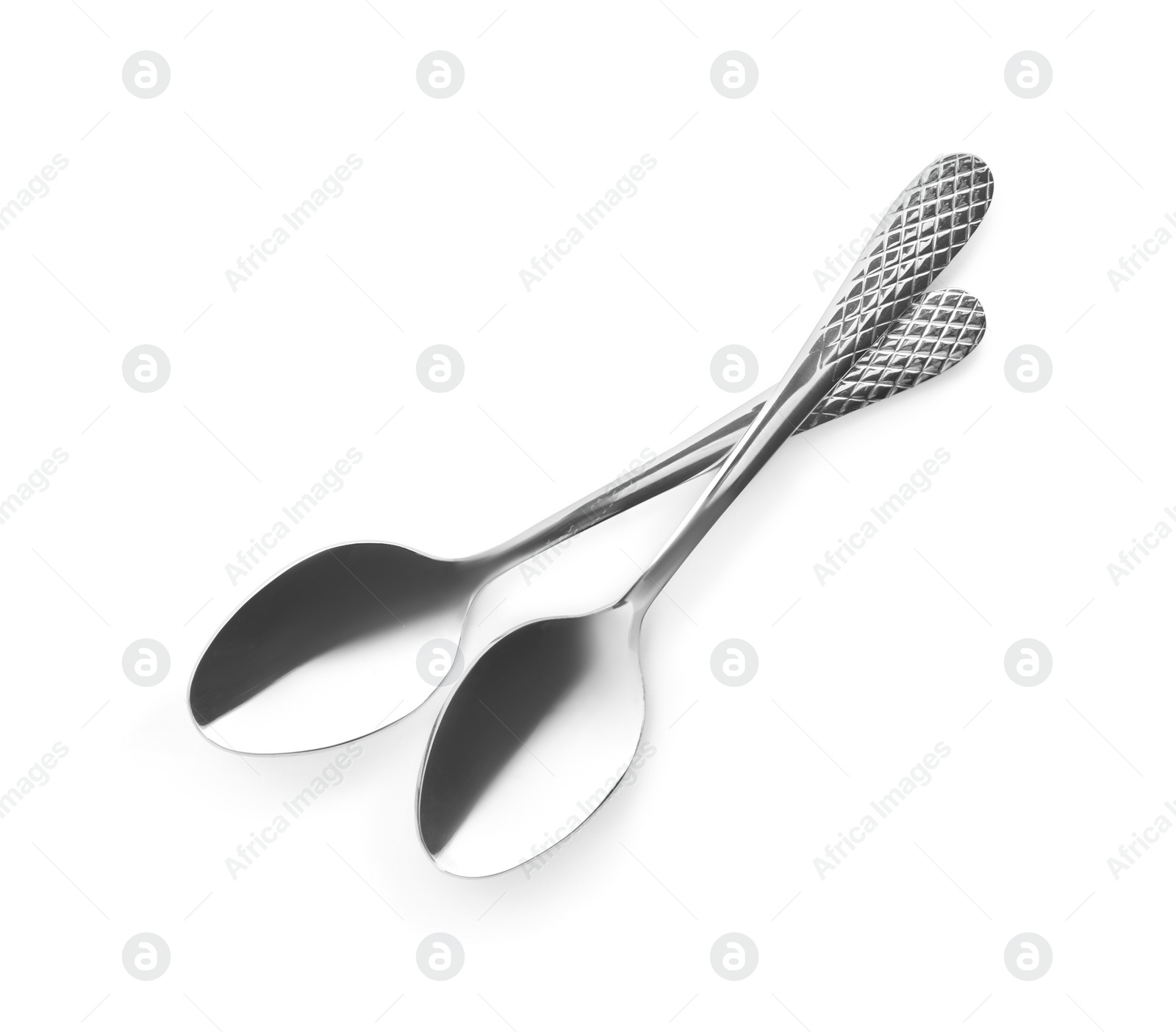 Photo of Clean shiny metal spoons on white background