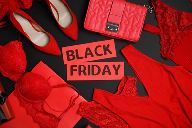 Photo of Stylish women's accessories, shoes, underwear and phrase Black Friday on dark background, flat lay