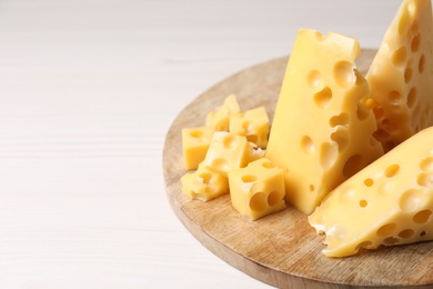 Tasty fresh cheese on white wooden table, closeup. Space for text