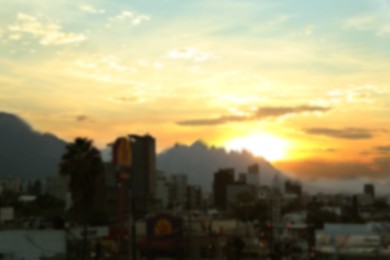 Picturesque view of city and mountains at sunset