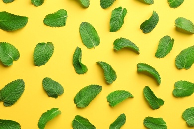 Fresh mint leaves on yellow background, flat lay