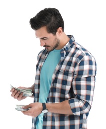 Handsome young man counting money on white background