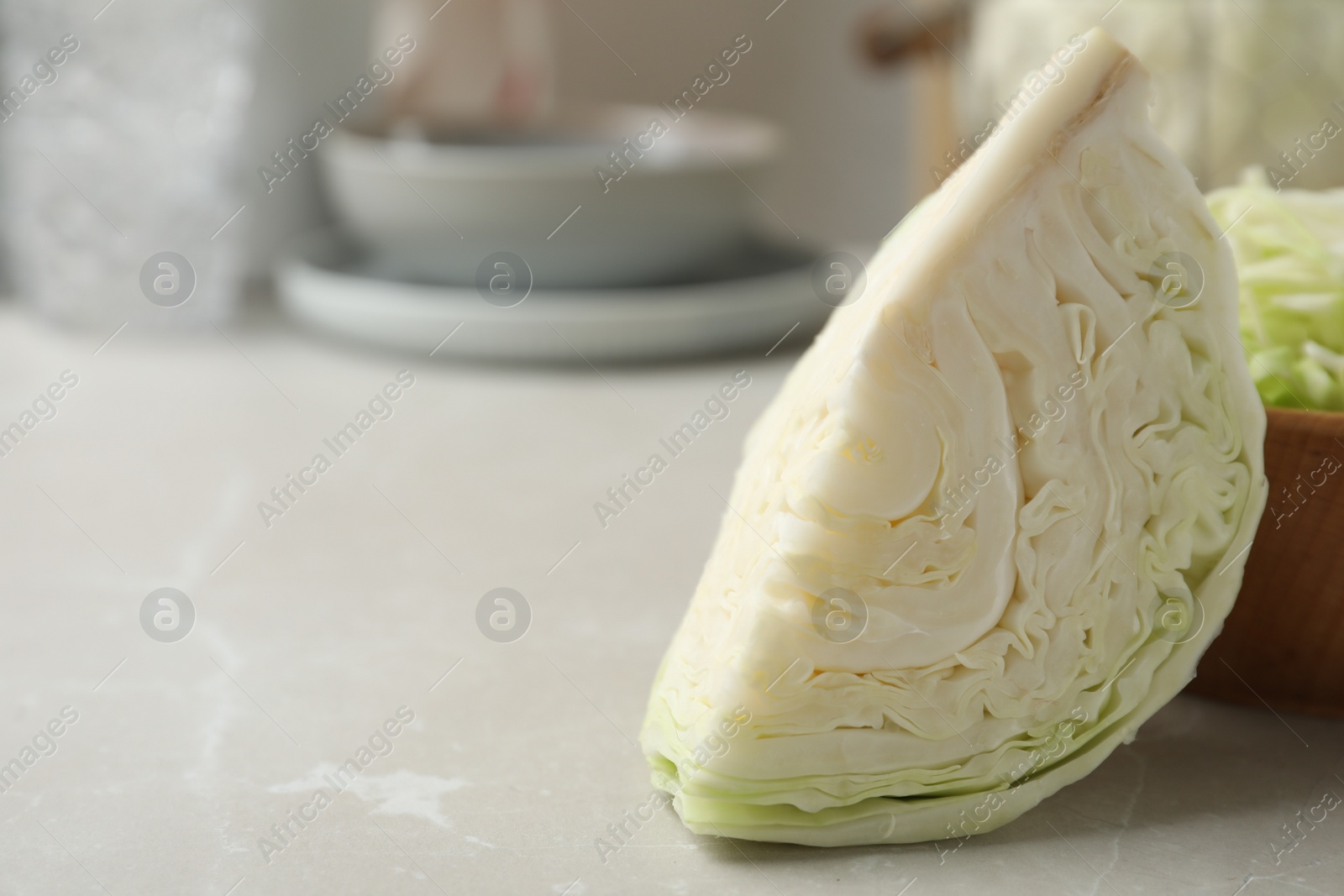 Photo of Fresh cabbage section on light table, closeup. Space for text