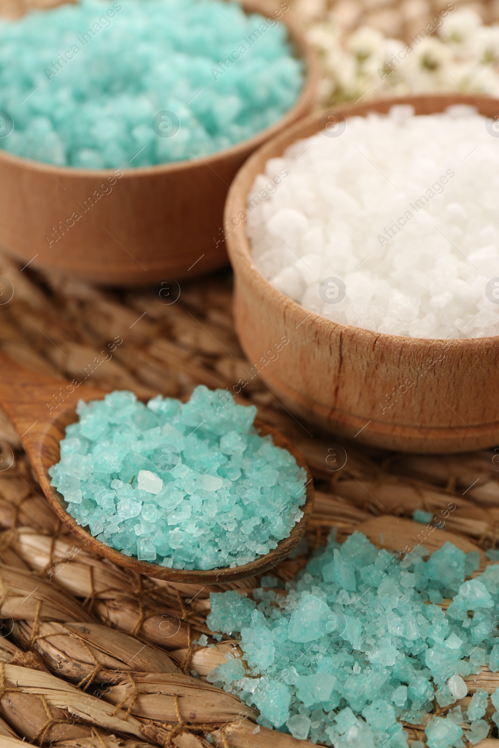 Photo of Aromatic sea salt on wicker mat, closeup