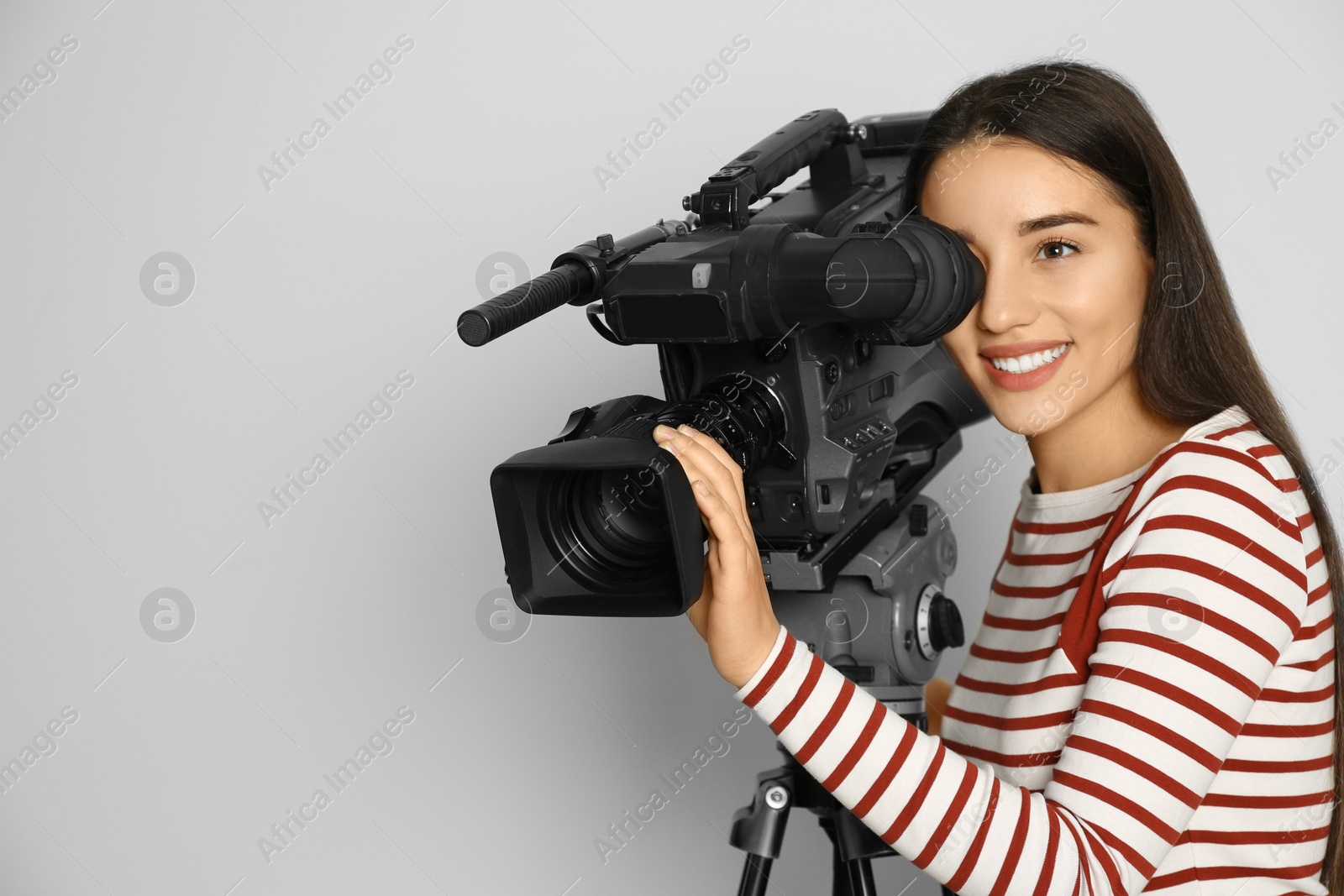 Photo of Operator with professional video camera on white background