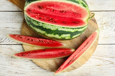 Photo of Yummy watermelon on white wooden table, top view