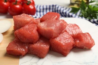 Photo of Cooking delicious goulash. Raw beef meat on board, closeup