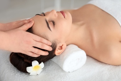 Young woman receiving massage in spa salon