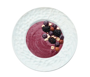 Plate with tasty acai smoothie on white background, top view