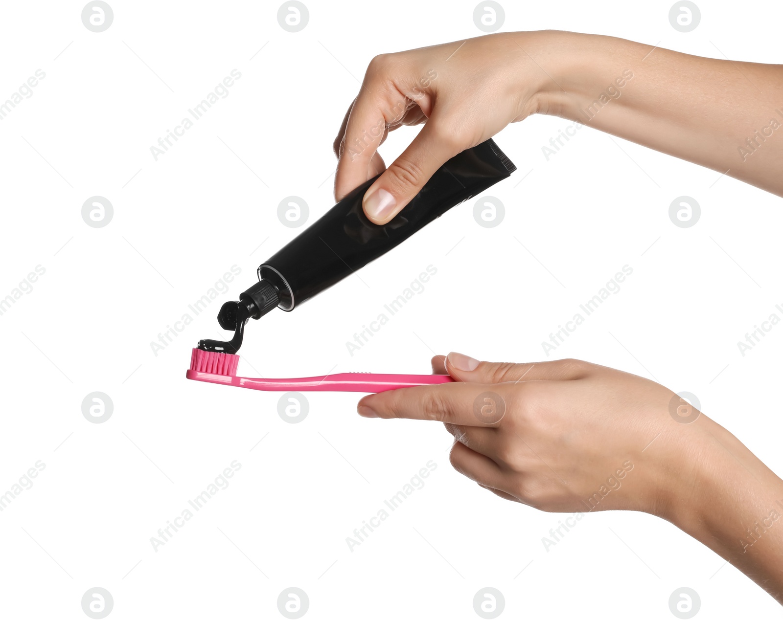 Photo of Woman applying charcoal toothpaste on brush against white background, closeup
