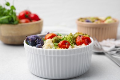 Photo of Delicious salad with cauliflower and tomato served on white table, closeup