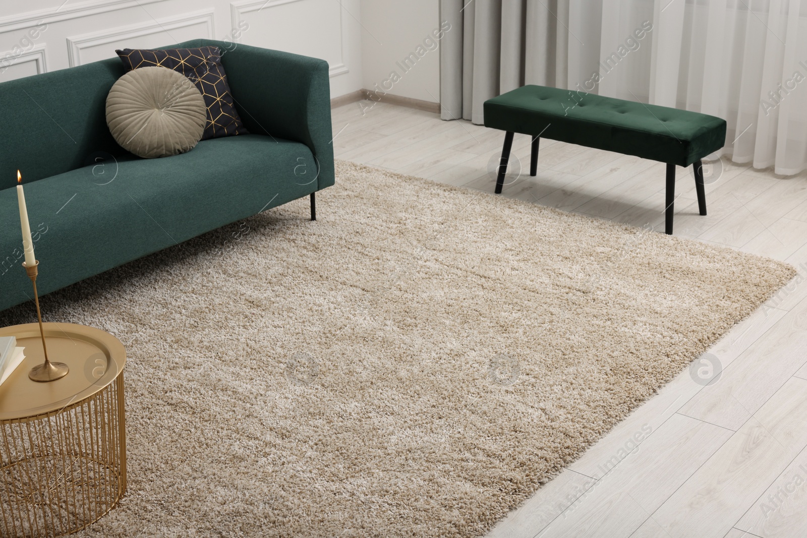 Photo of Stylish living room with soft beige carpet, coffee table and sofa. Interior design