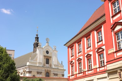 Photo of Beautiful old buildings against blue sky, low angle view