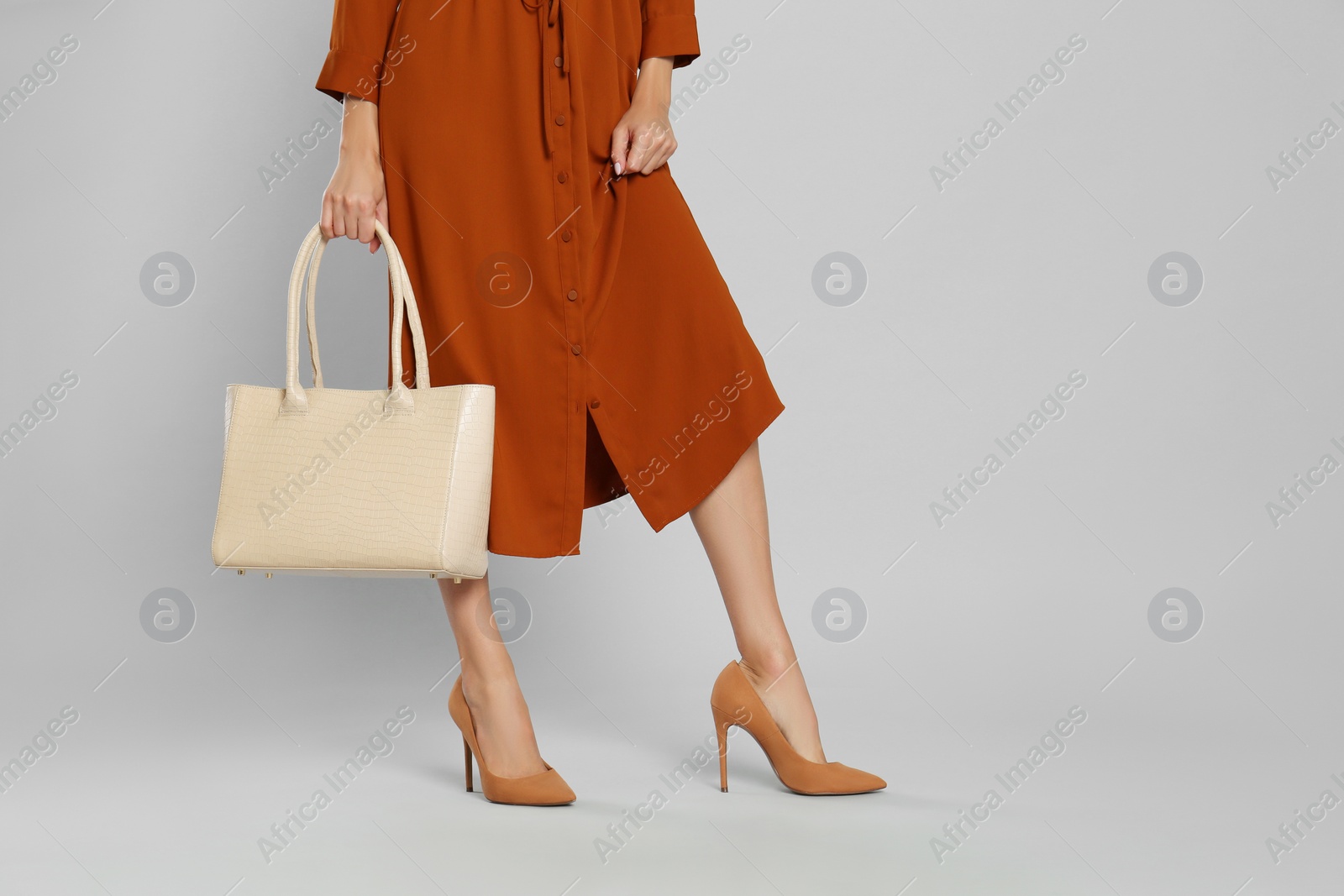 Photo of Woman with stylish bag on grey background, closeup