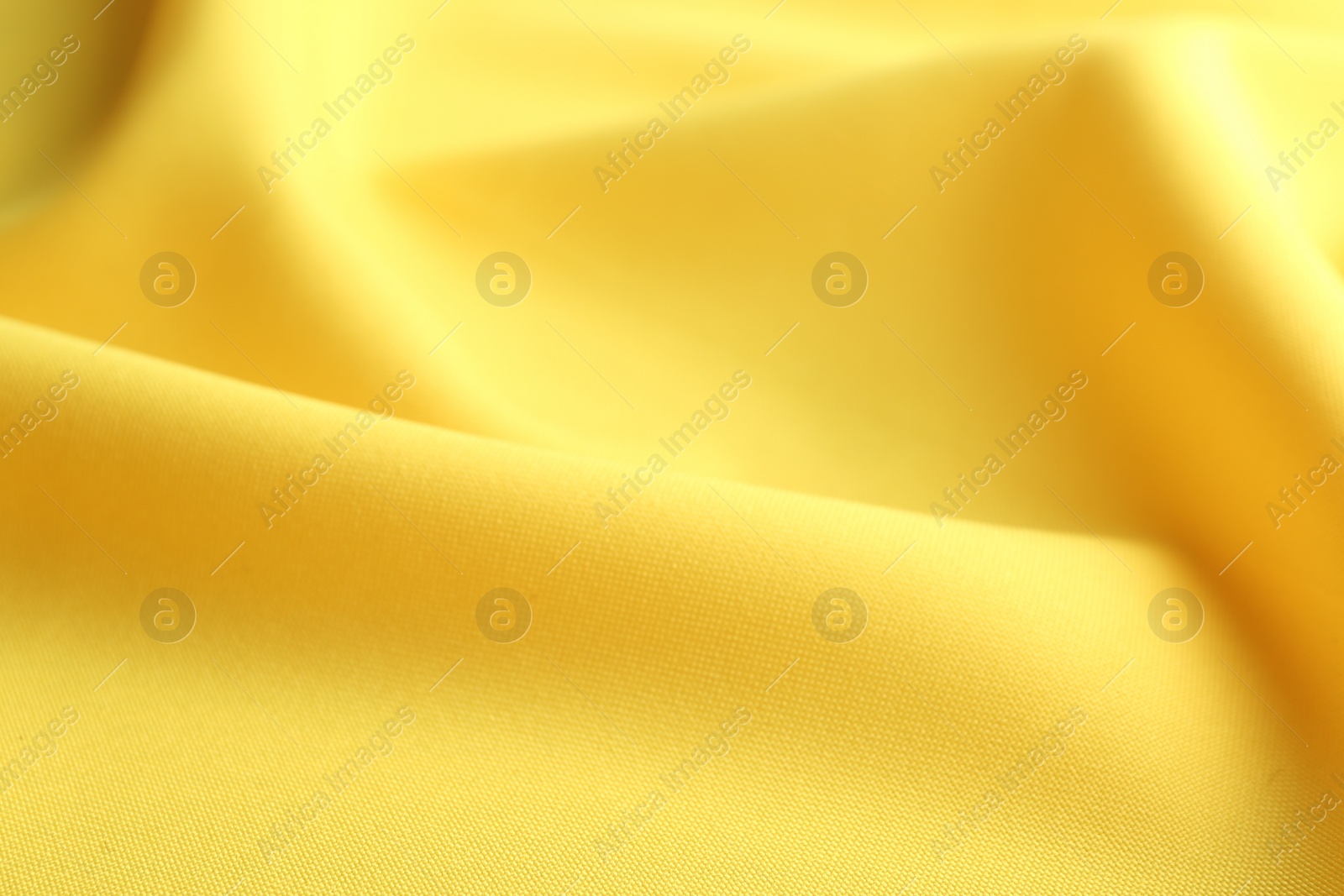 Photo of Texture of beautiful yellow fabric as background, closeup