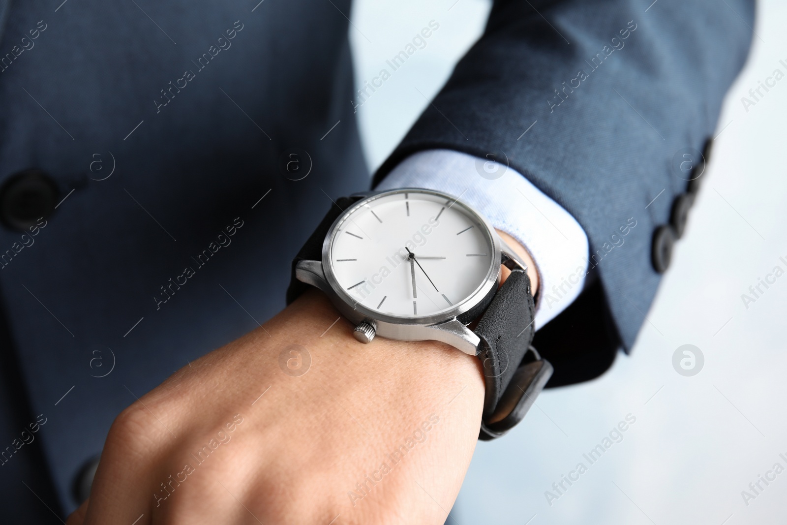 Photo of Businessman with stylish wrist watch, closeup. Time management